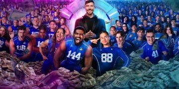 MrBeast stands at the center of the Beast Games arena surrounded by hundreds of contestants wearing blue numbered jerseys, with piles of cash and money flying through the air, representing the high-stakes Amazon Prime competition show.